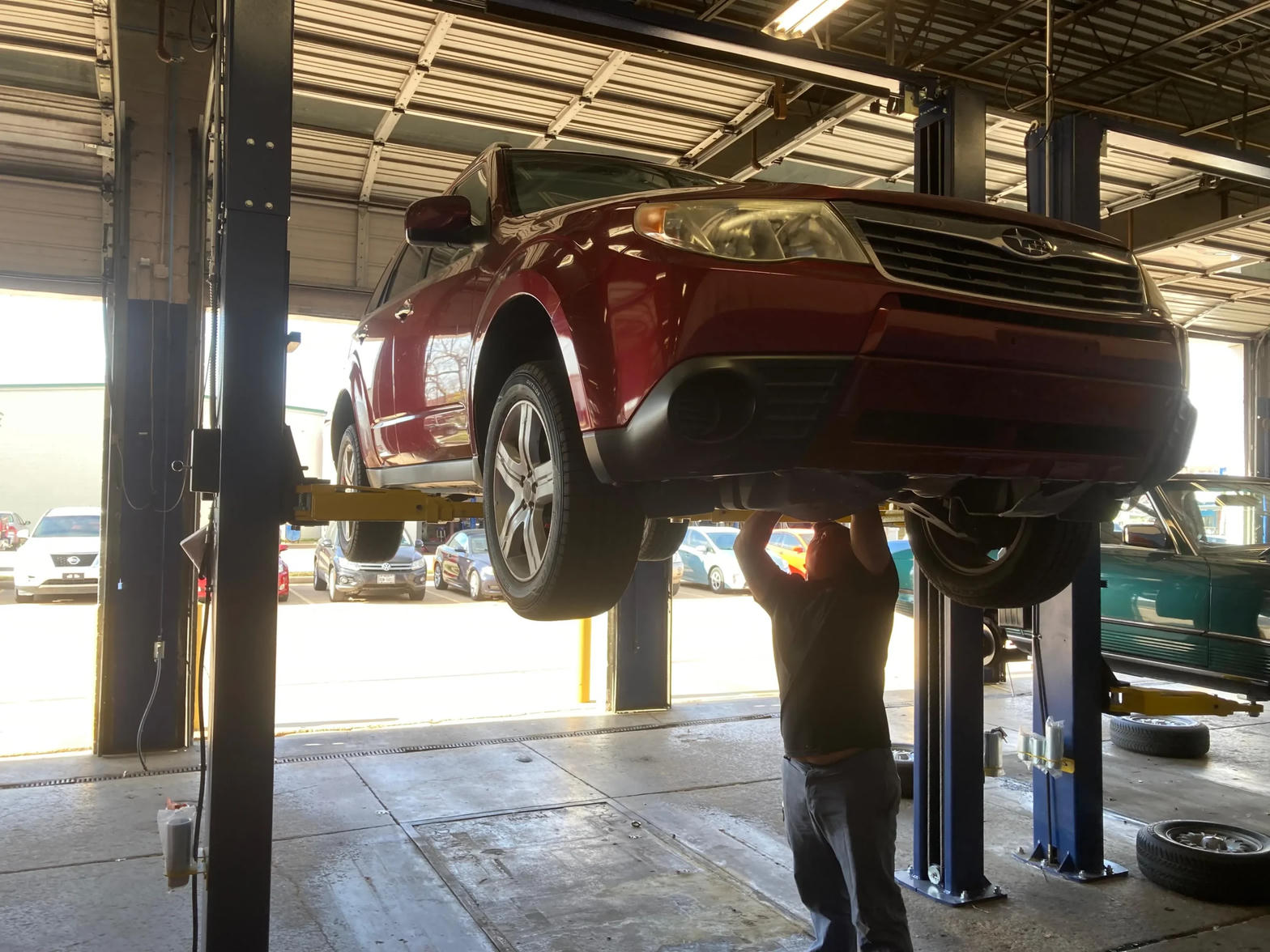 Example photo of a vehicle on a service lift. Not the actual Weatherford store.